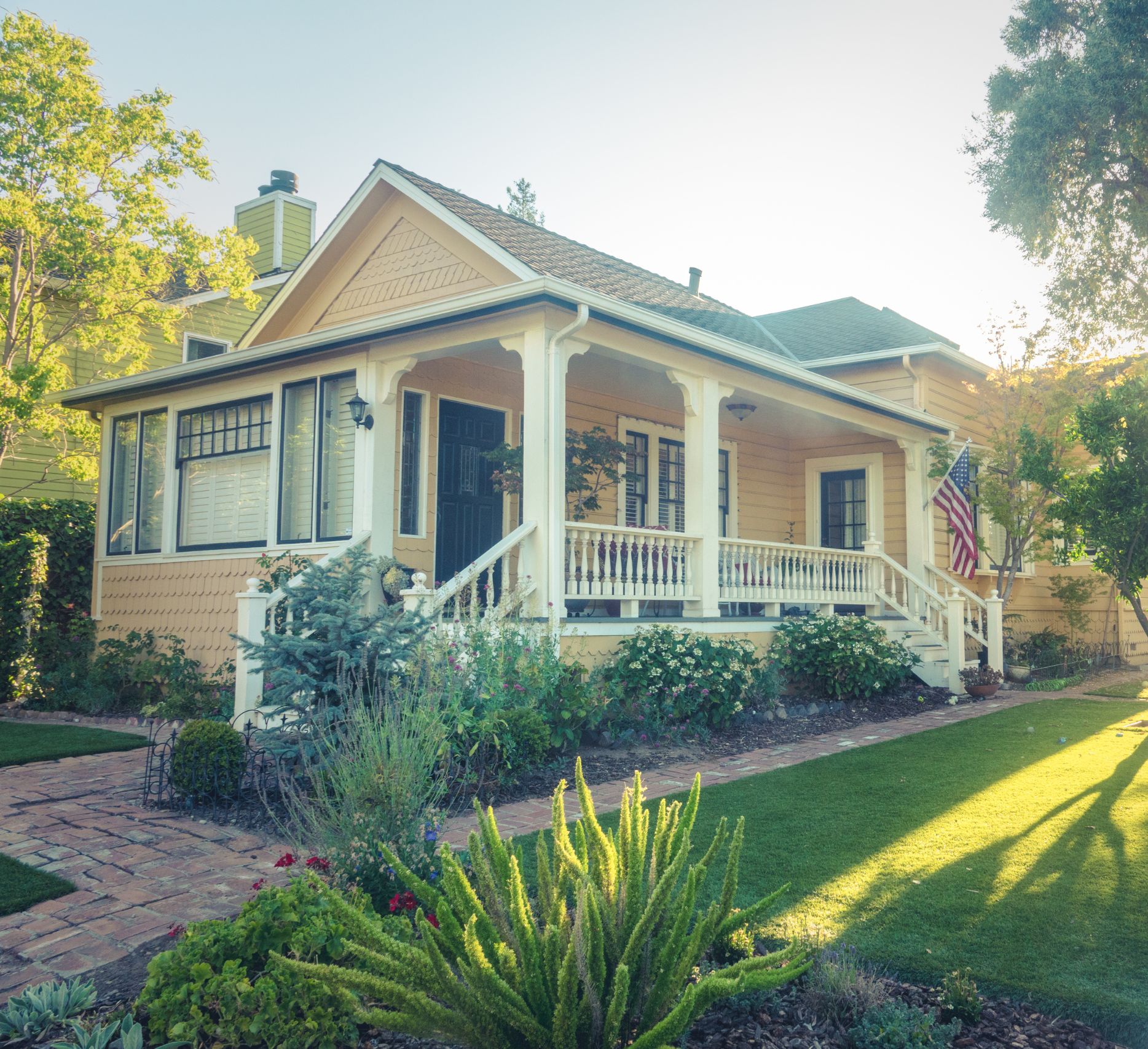 Well-maintained home with lush landscaping, representing reliable home security check services.